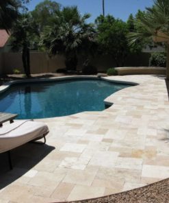 French pattern paving around a curved inground pool