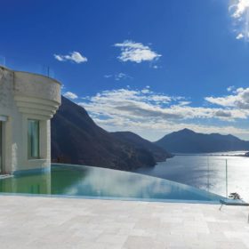 Infinity pool with french pattern limestone tiles