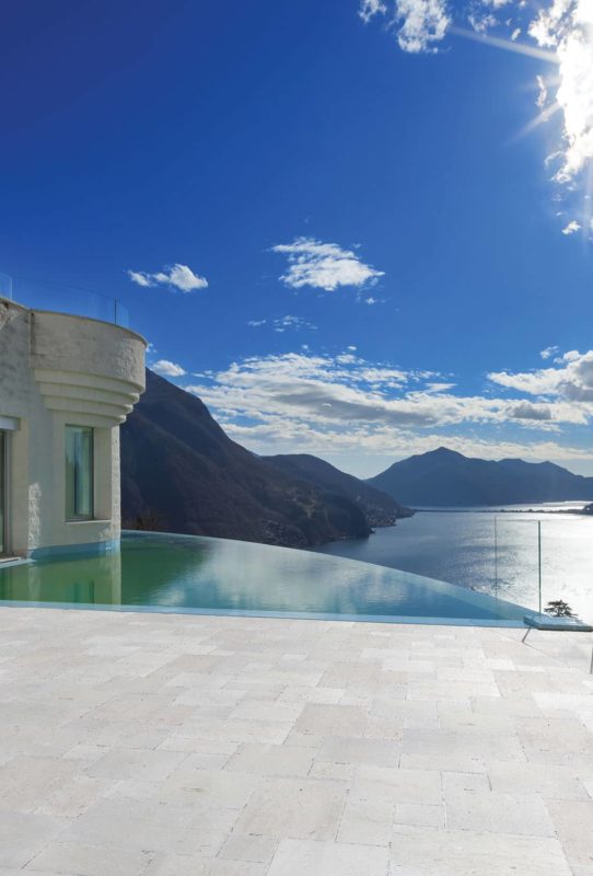 Infinity pool with french pattern limestone tiles