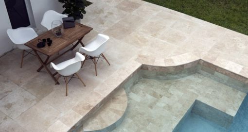 Square tiles around pool with curved corner