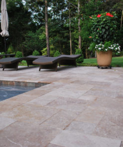 Brown pool coping tiles with surrounding pool paving on a tiles pool